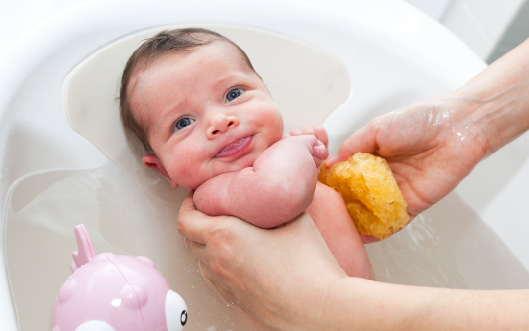 A baby splashing happily in a warm bath, surrounded by bubbles and bath toys. The parent is gently washing the baby with a soft washcloth, preparing them for bedtime. The soothing sounds of water and the loving care of the parent help create a relaxing environment for the baby's nighttime routine